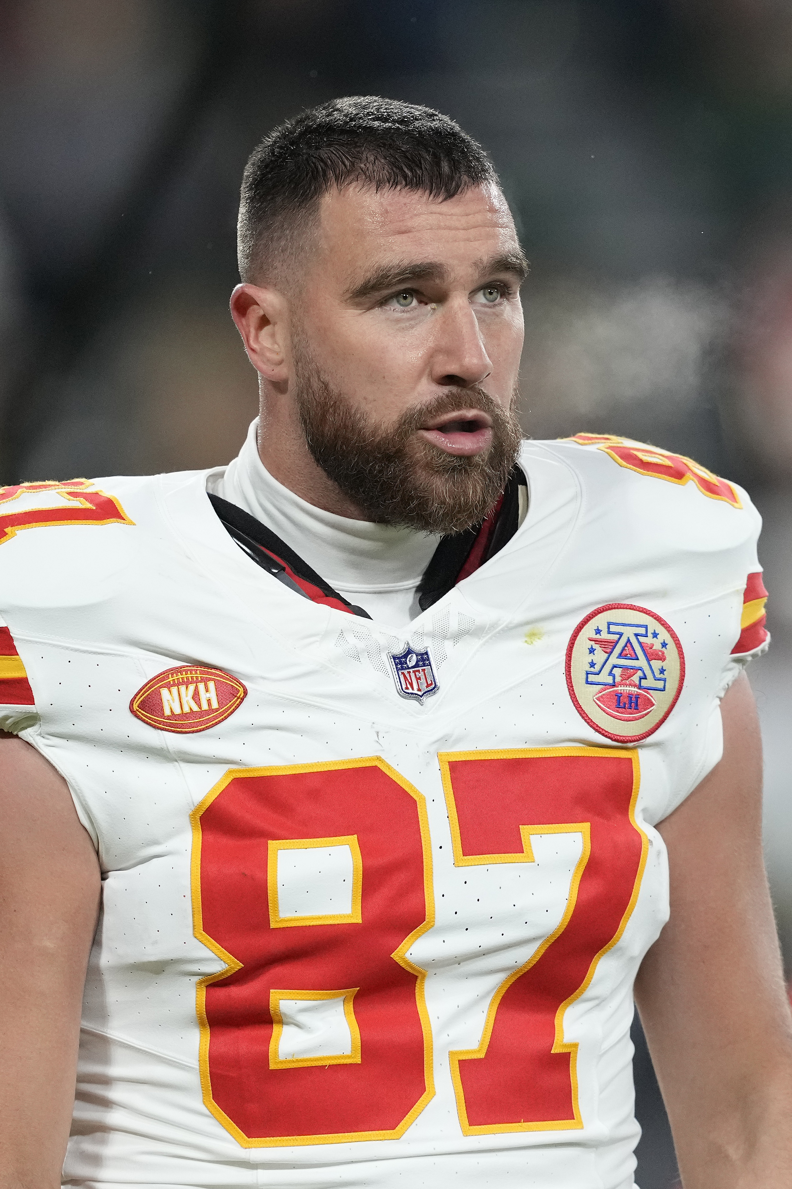 Travis Kelce, in a football jersey with number 87, on the field during a game