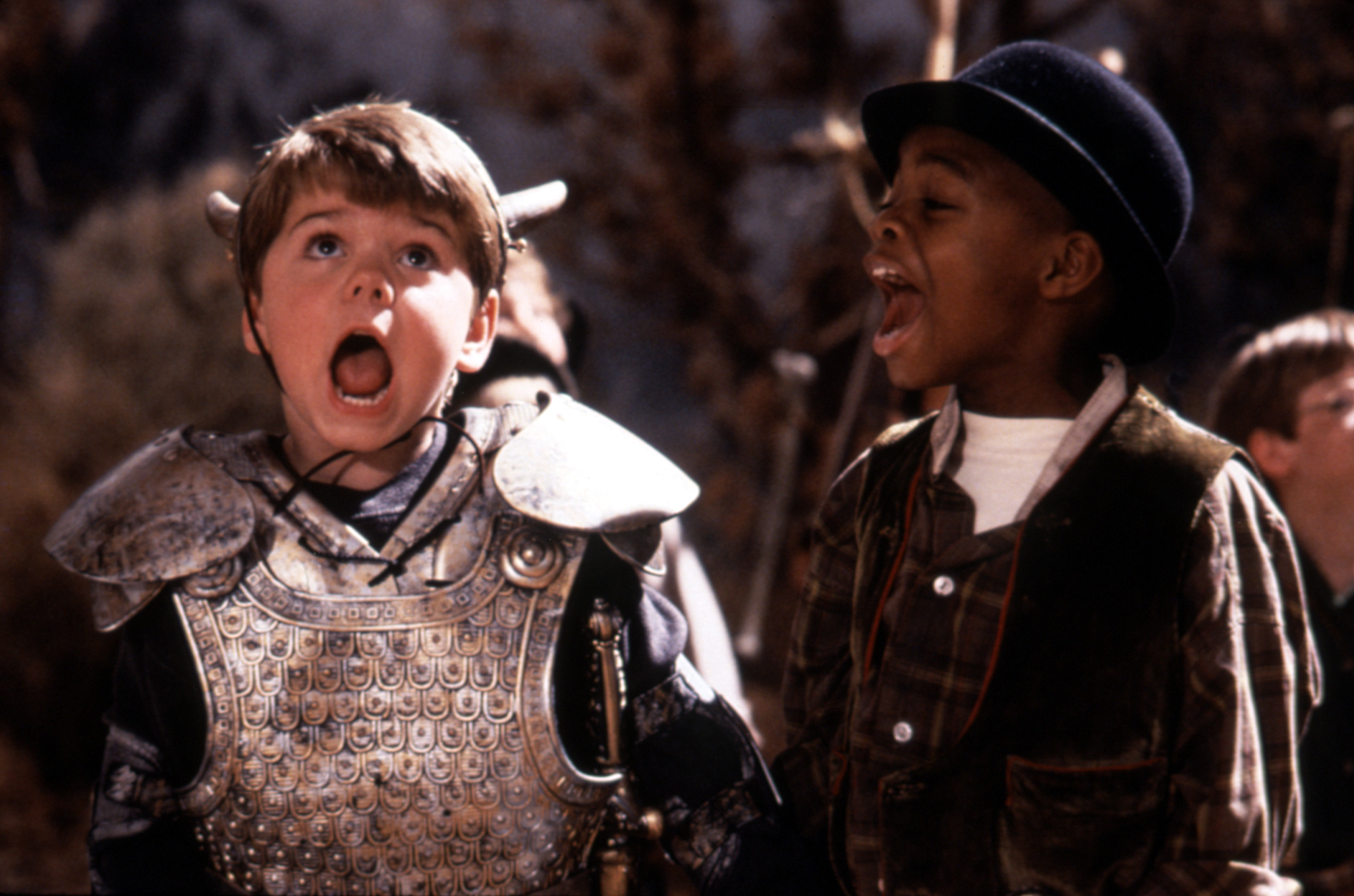Travis Tedford in knight armor and Kevin Jamal Woods in a bowler hat/plaid shirt as they both scream in a scene from &quot;The Little Rascals&quot;