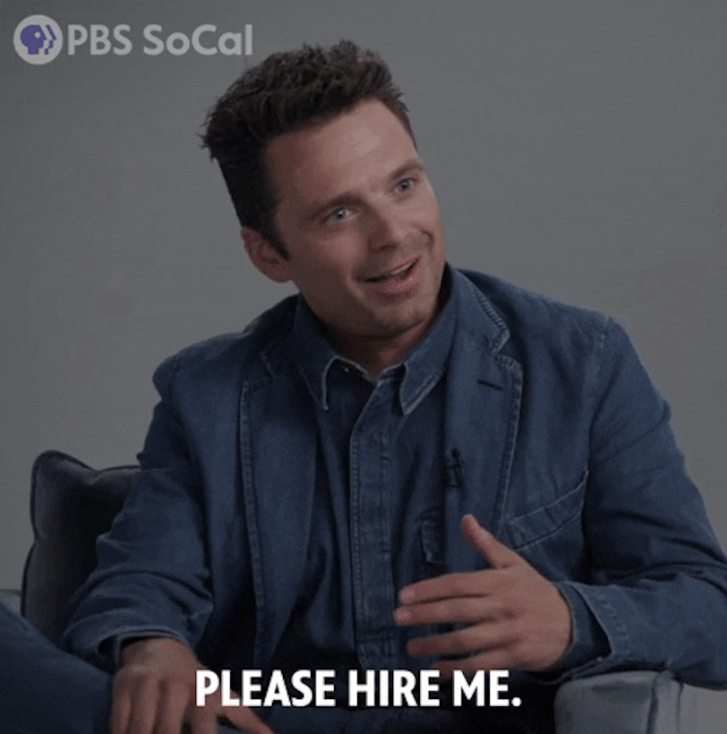 Sebastian Stan smiling and gesturing, wearing a casual denim outfit, with