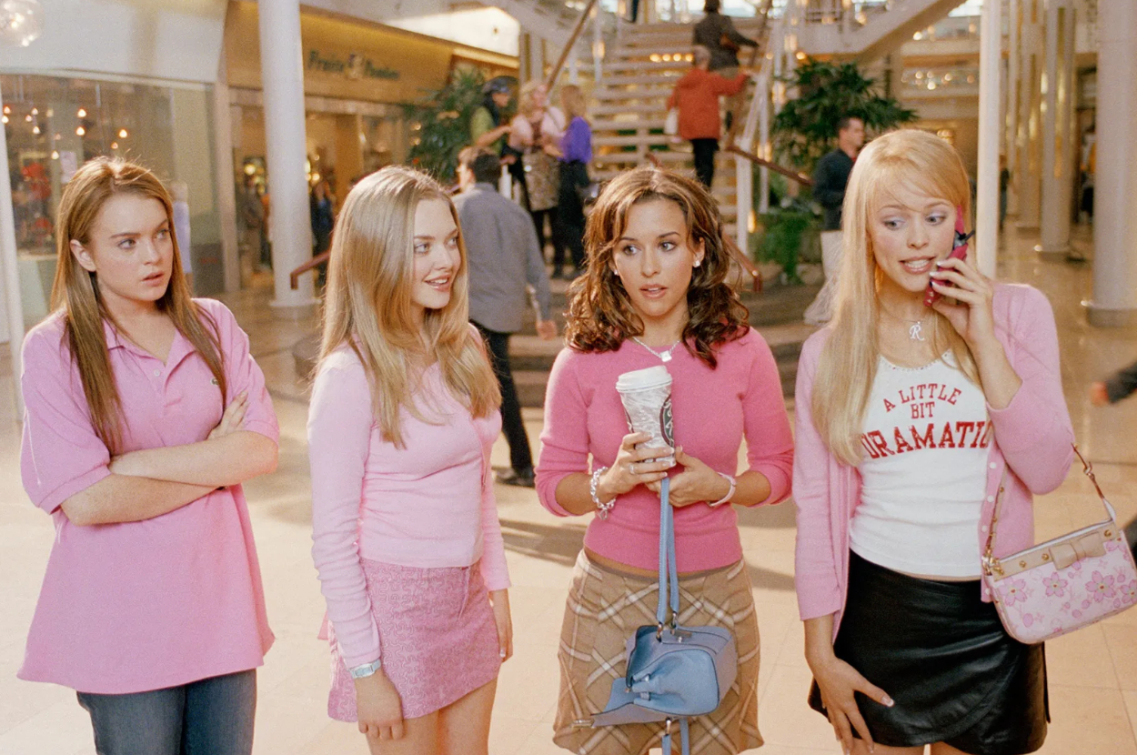 Lindsay Lohan, Amanda Seyfried, Lacey Chabert, and Rachel McAdams in a mall scene from "Mean Girls," all wearing pink outfits