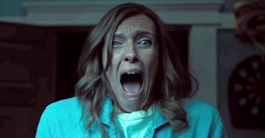 Toni Collette, looking shocked and frightened, appears to be screaming in a scene from a movie