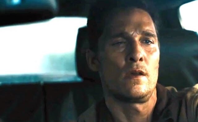 Matthew McConaughey looking intensely while driving a car in a scene from a movie