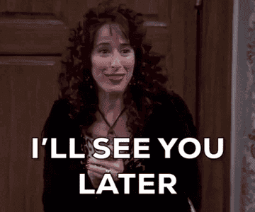 A person with curly hair and a dark outfit smiles and gestures while saying "I'll see you later"