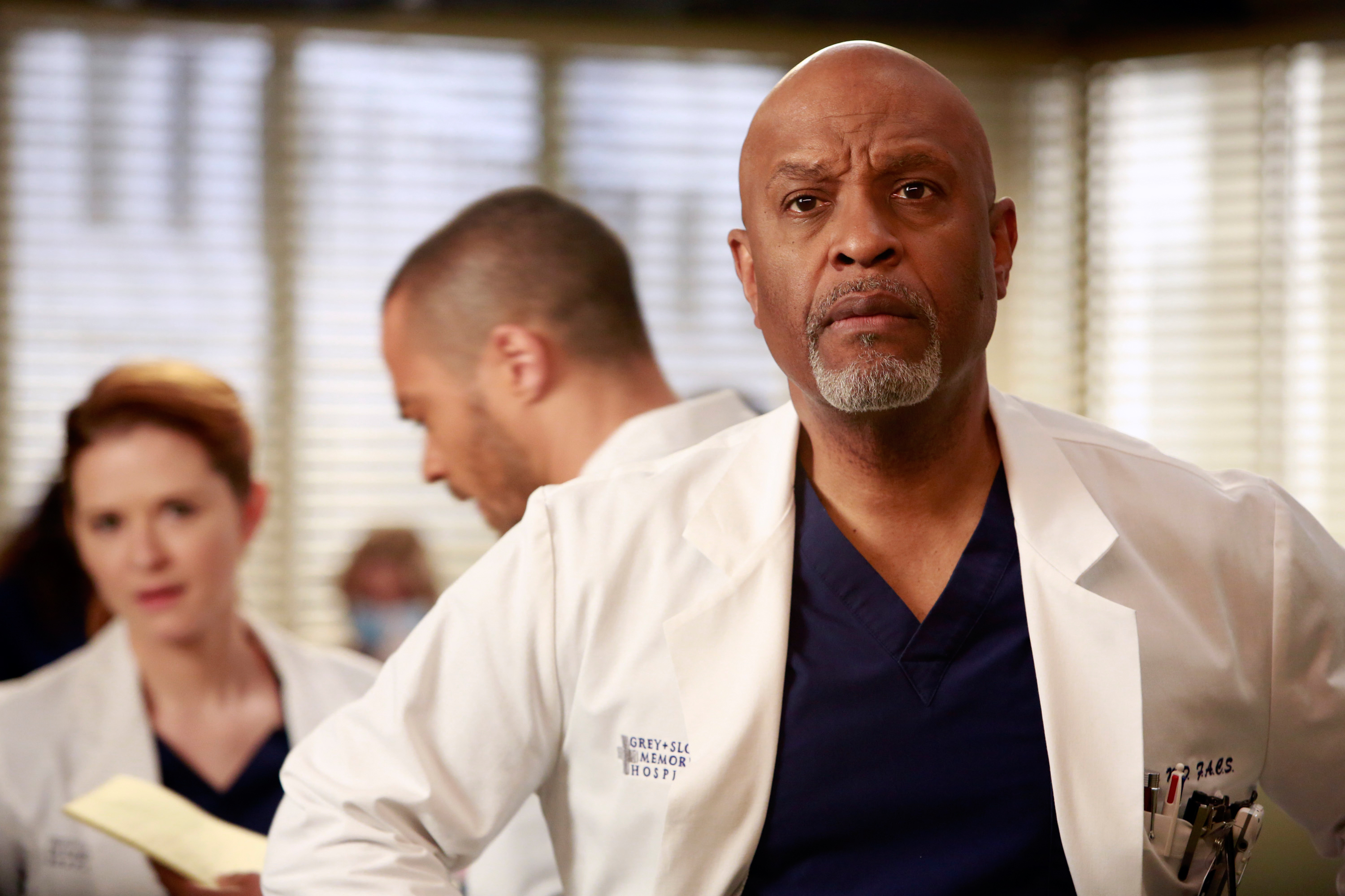 Richard Webber, April Kepner, and Jackson Avery wearing medical coats in a scene from Grey's Anatomy