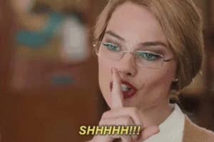 A person with glasses and red lipstick holds a finger to their lips, implying "quiet," with the word "SHHHHH!!!" written at the bottom of the image