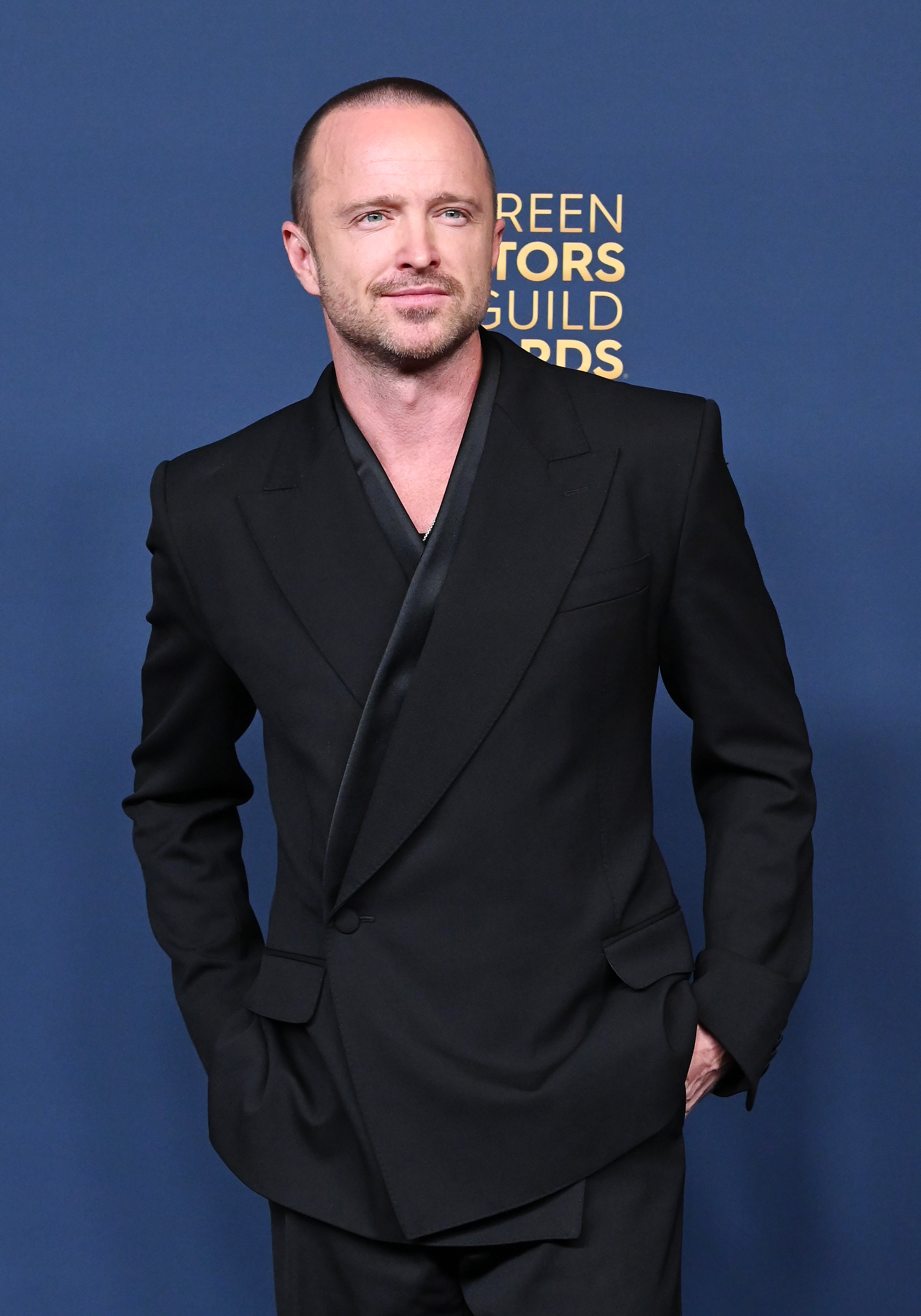 Aaron Paul poses in a stylish, black double-breasted suit at the Screen Actors Guild Awards