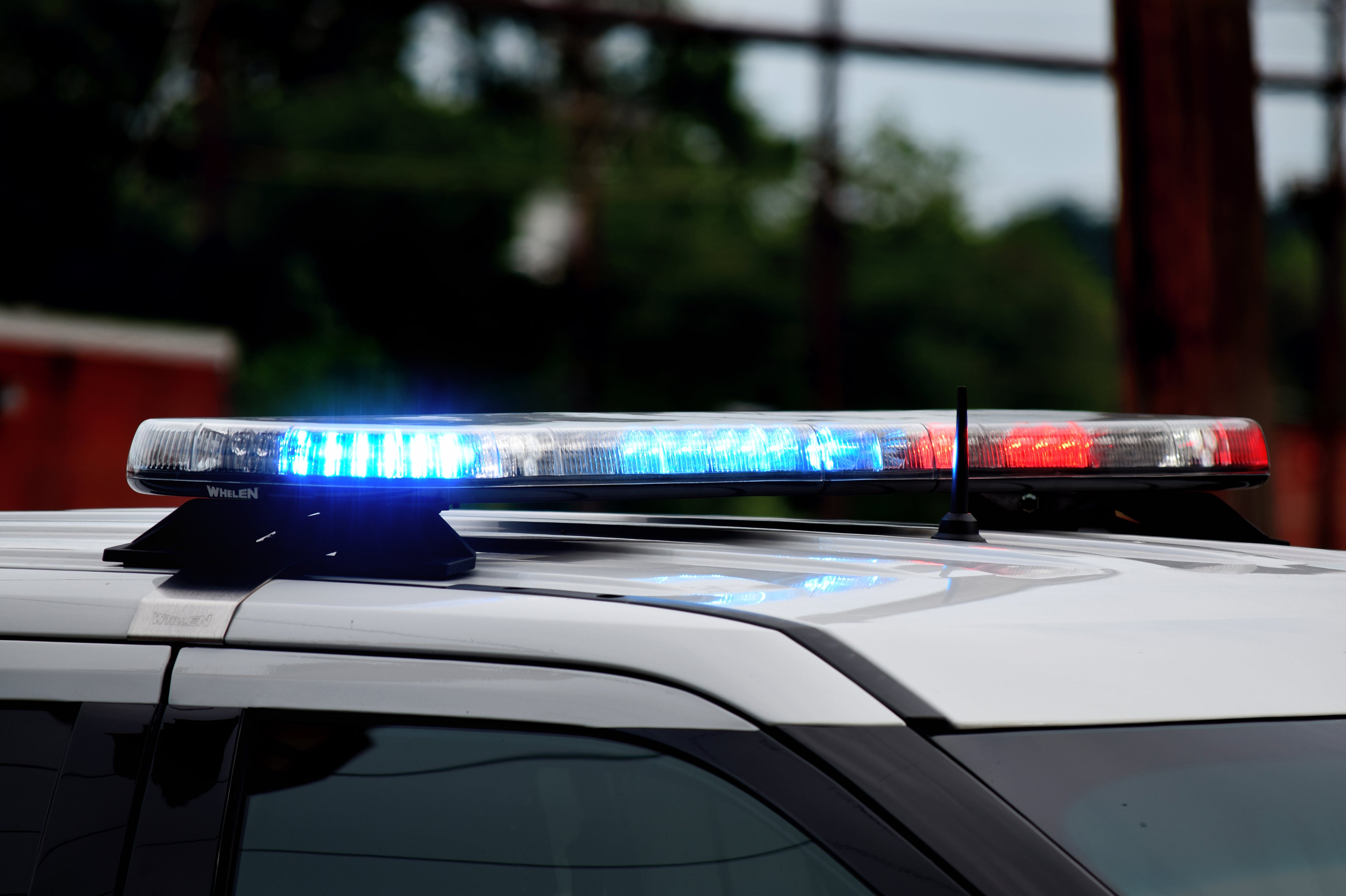 Close-up of a police car roof with flashing blue and red lights
