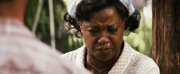 Viola Davis in a scene from a movie wearing period clothing with a serious, contemplative expression
