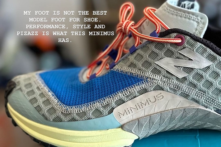 Close-up of a New Balance Minimus sneaker on a blue box, with text reading, "My foot is not the best model foot for shoe performance, style and pizazz is what this Minimus has."