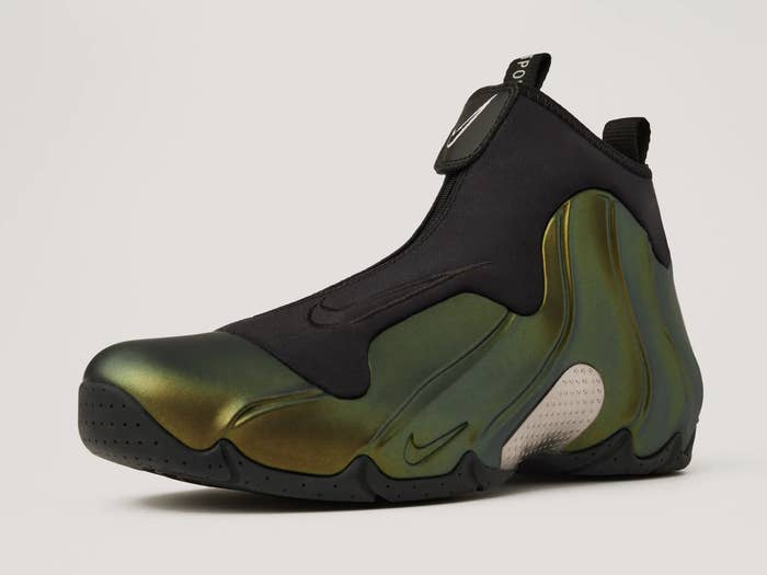 Close-up of a Nike Air Flightposite sneaker with a fluid, futuristic design featuring a glossy, metallic finish and streamlined shape