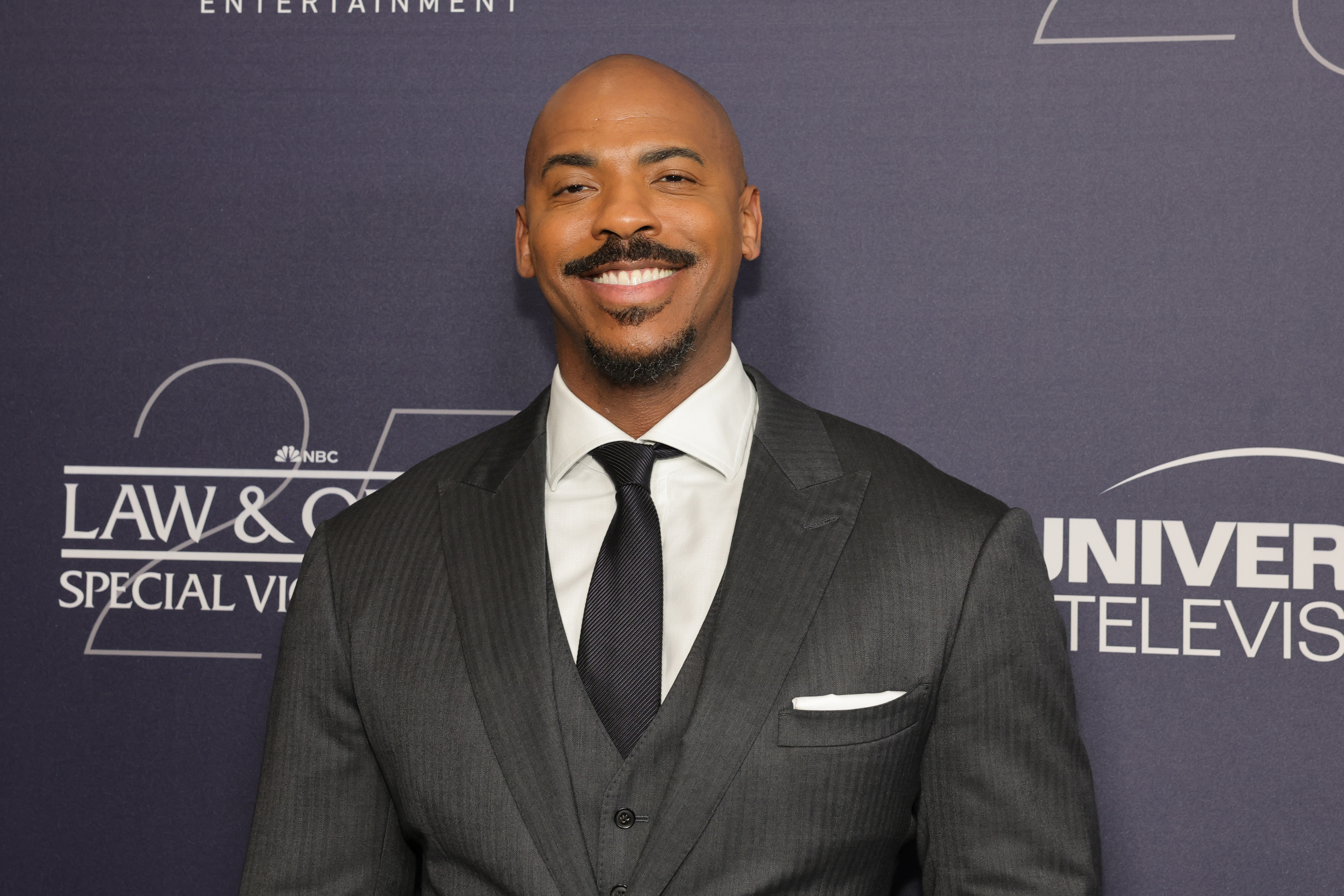 Mehcad Brooks in a dark suit and tie at the Law & Order Special Victims Unit event