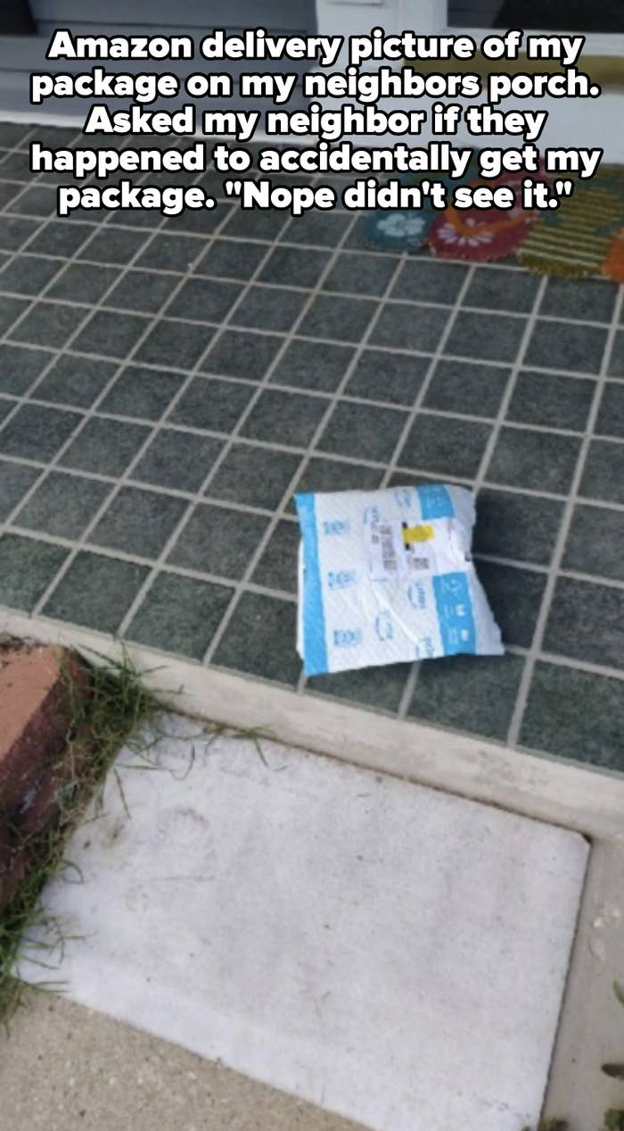 A small package lies on a tiled doorstep in front of a house. No people are present