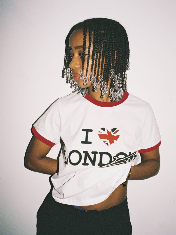 Person with beaded braids wearing an &quot;I ❤️ London&quot; t-shirt