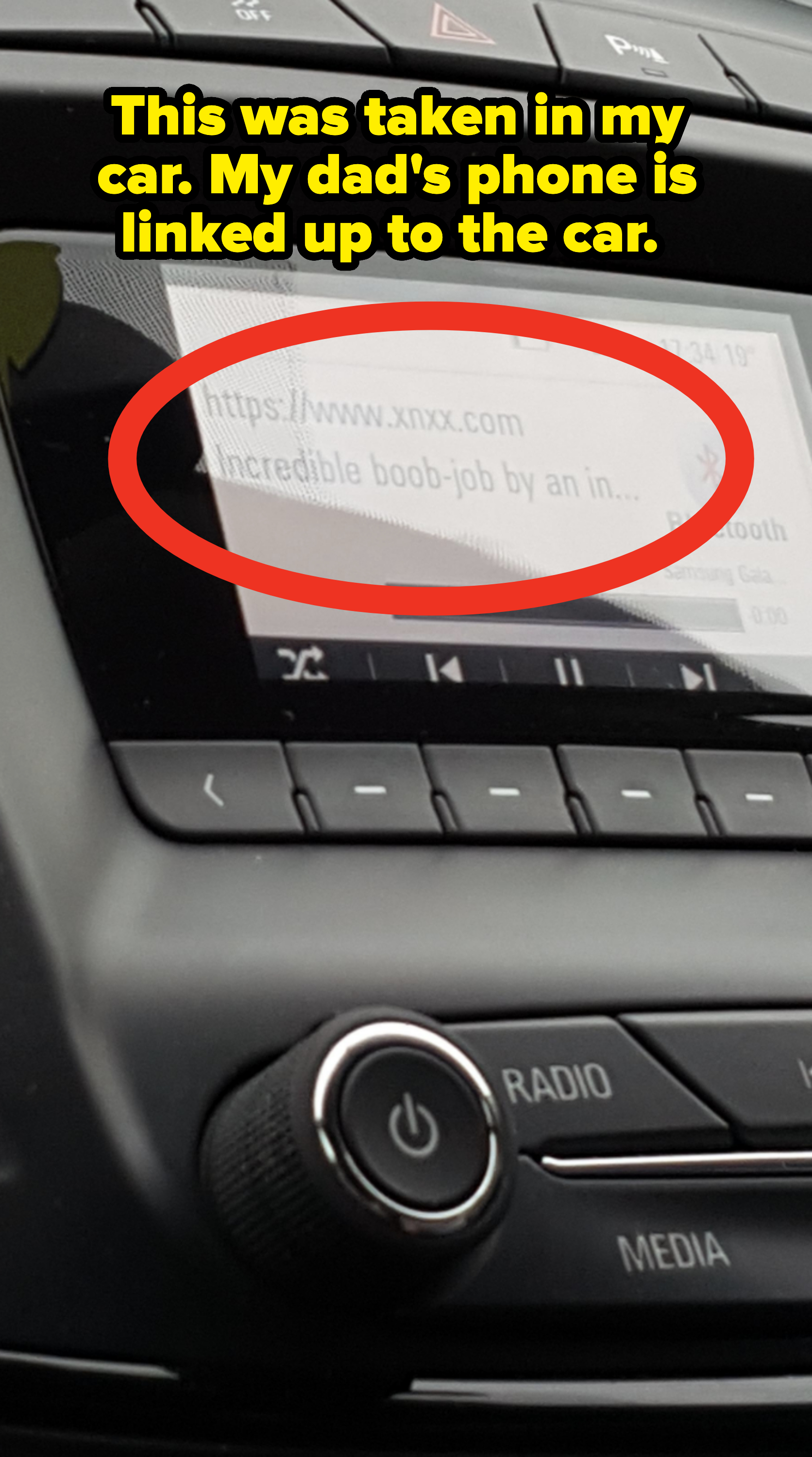 Car dashboard screen displaying inappropriate content with explicit language, showing the title "Incredible boob-job by an in…". Below, a song is playing via Bluetooth