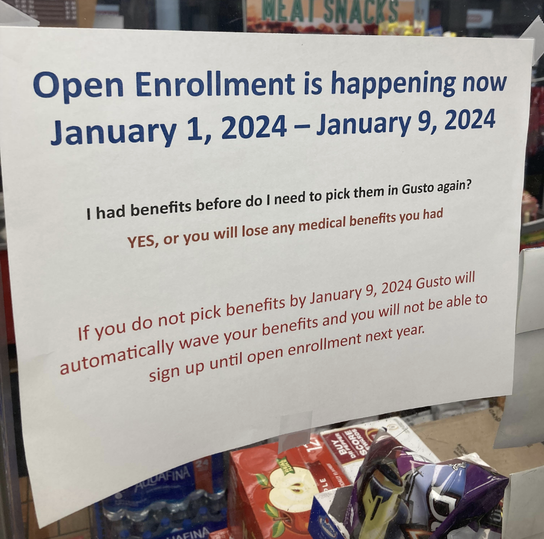 Sign reads: "Open Enrollment is happening now January 1, 2024 - January 9, 2024; pick benefits by January 9, 2024, or lose medical benefits; automatic loss if not selected."