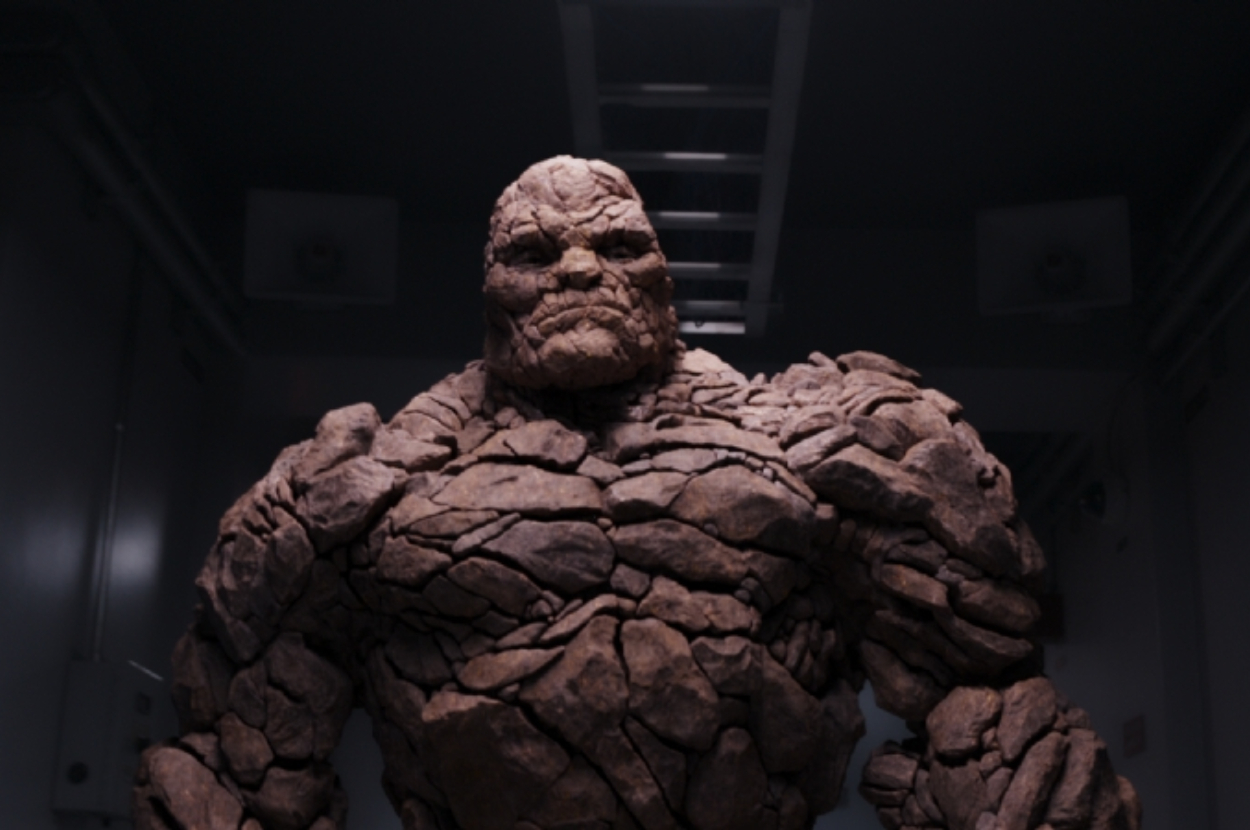 The Thing from Fantastic Four, a character with a rocky exterior, stands in a dimly lit room