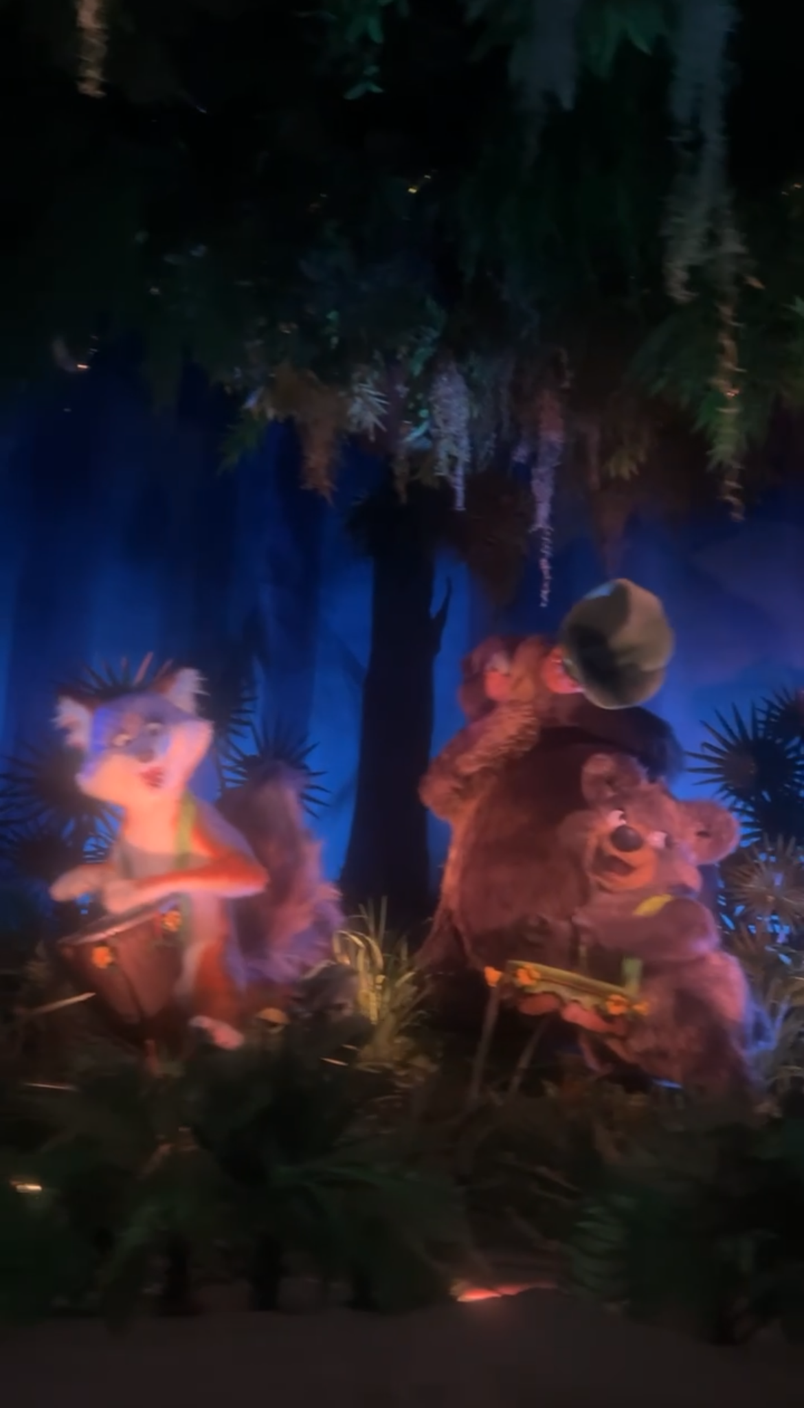 Animatronic scene from Disney&#x27;s Country Bear Jamboree featuring Henry, Liver Lips McGrowl, Teddi Barra, and Gomer performing in a forest setup