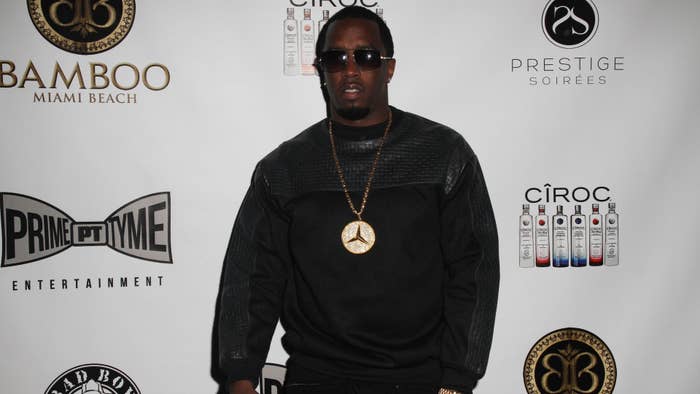Sean &quot;Diddy&quot; Combs at an event wearing black clothing with a large gold medallion necklace. Logos for Bamboo Miami Beach, Prime Time Entertainment, Prestige Soirées, Ciroc, and Bad Boy Entertainment in the background