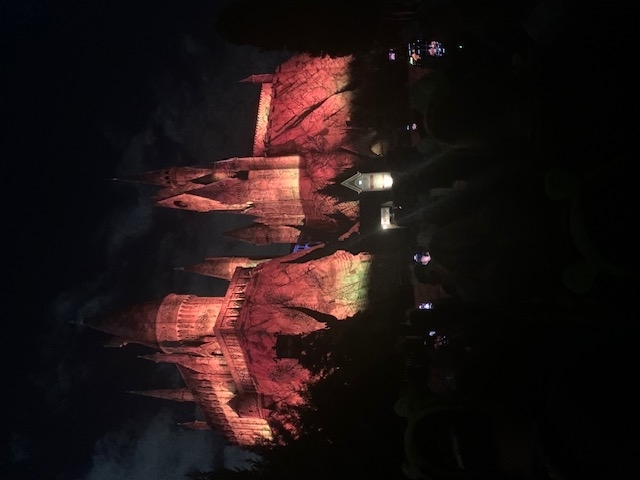 The image shows an illuminated view of Hogwarts Castle at night, from the Harry Potter series