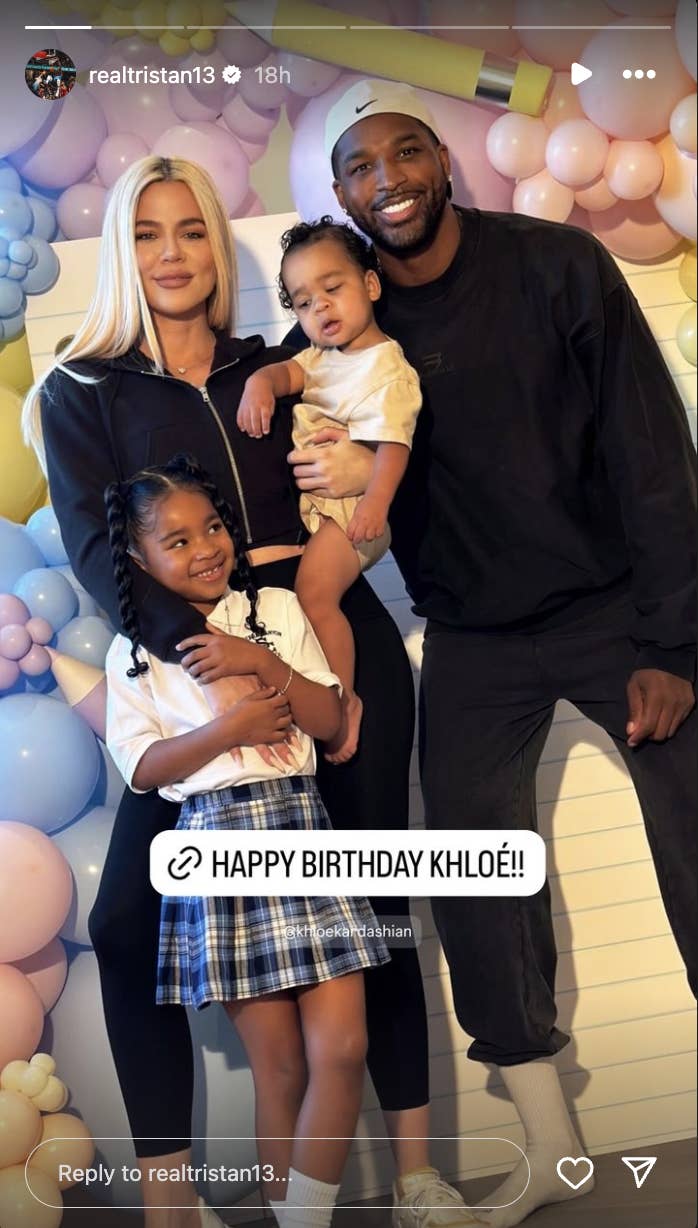 Khloé Kardashian and Tristan Thompson pose with their children. A Happy Birthday message to Khloé is on the photo