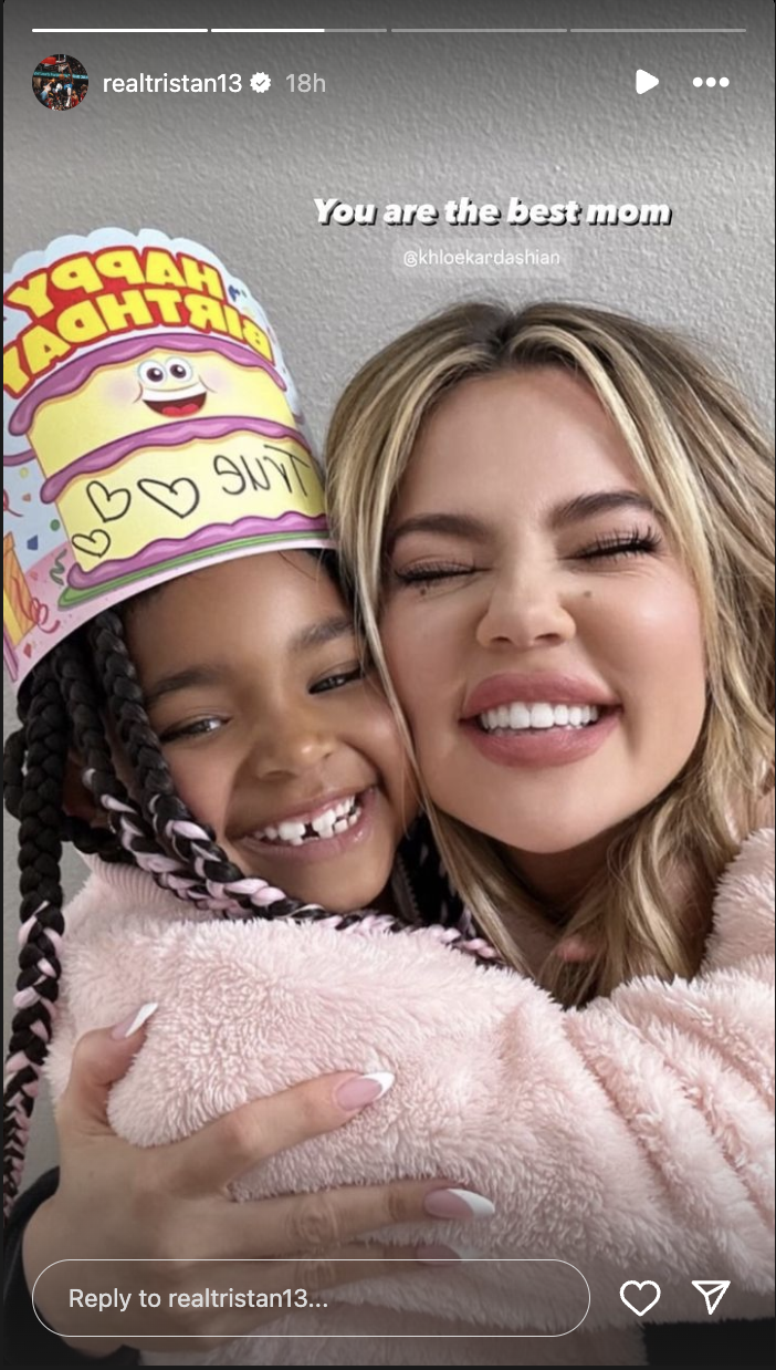 Khloe Kardashian hugs a child wearing a birthday hat. The text reads, &quot;You are the best mom.&quot;