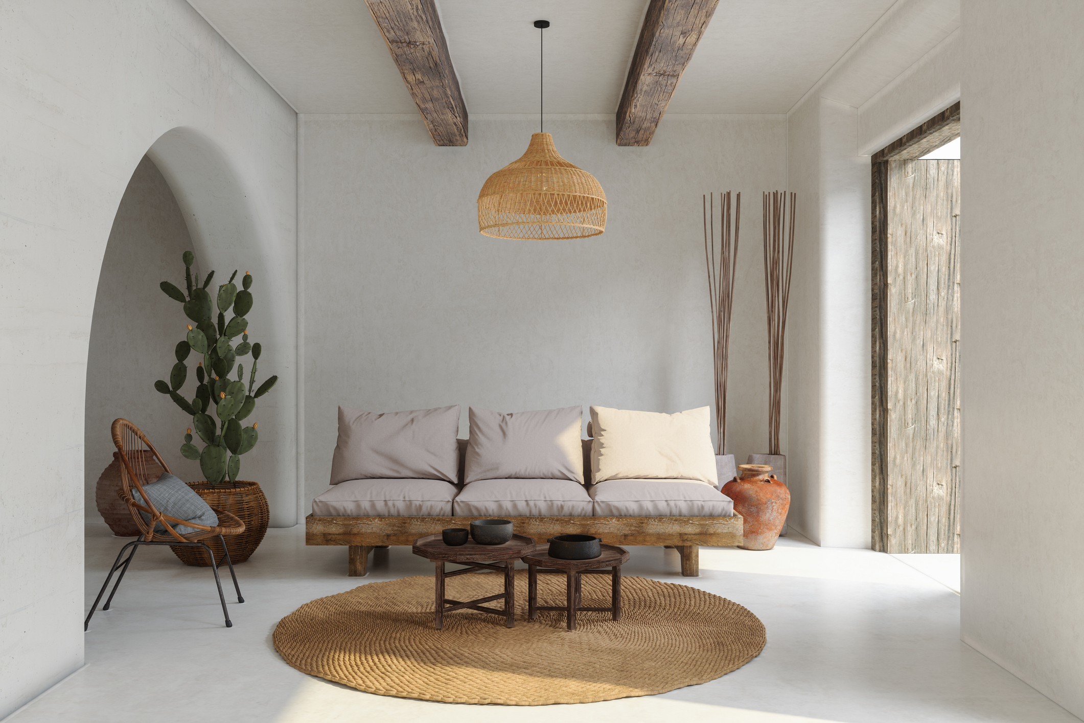 Modern minimalist living room with light wooden furniture, a woven rug, a cactus in a pot, a wicker chair, and a pendant light