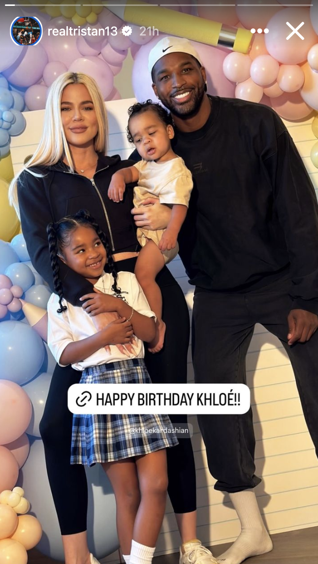 Khloé Kardashian and Tristan Thompson pose with their two daughters at a birthday celebration with balloon decorations. Text reads, "HAPPY BIRTHDAY KHLOÉ!!"