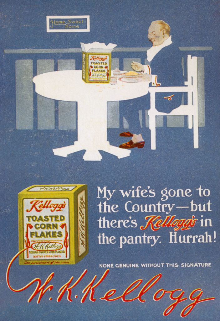 An featuring W.K. Kellogg at a table beside a Kellogg's Toasted Corn Flakes box. Text: "My wife's gone to the Country – but there's Kellogg's in the pantry. Hurrah!"