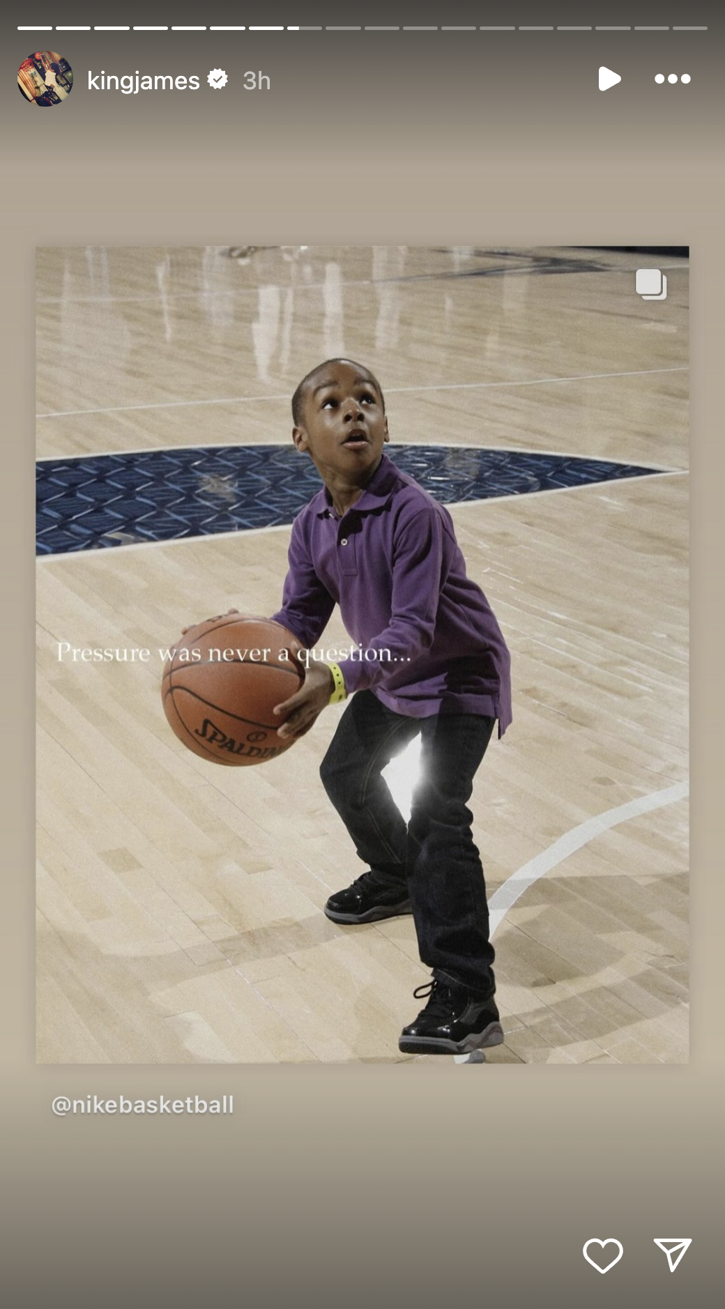 Young boy, likely on a basketball court, holding and preparing to shoot a basketball. Text on image reads, &quot;Pressure was never a question... @nikebasketball.&quot;