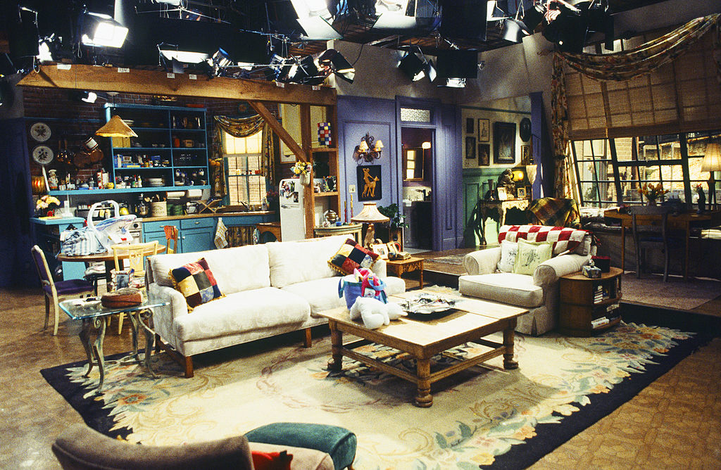 The image showcases the set of the popular '90s TV show "Friends," featuring Monica's apartment, with its distinctive decor and furniture