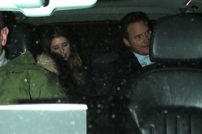 Katherine Schwarzenegger and Chris Pratt are seated in the back of a dimly lit car. Katherine looks down, and Chris glances at someone or something off-camera