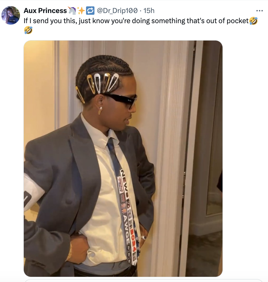 A person in a suit with hair clips and a necktie stands in a hallway, wearing sunglasses. Tweet text above reads, &quot;If I send you this, just know you're doing something that's out of pocket.&quot;