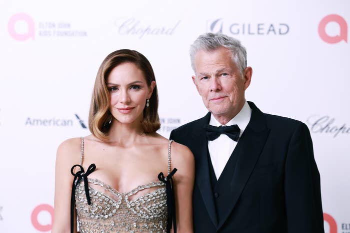 Katharine McPhee in an embellished dress and David Foster in a tuxedo pose at an event