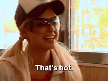 Paris Hilton wearing a cap and sunglasses smiling with the text &quot;That's hot.&quot;