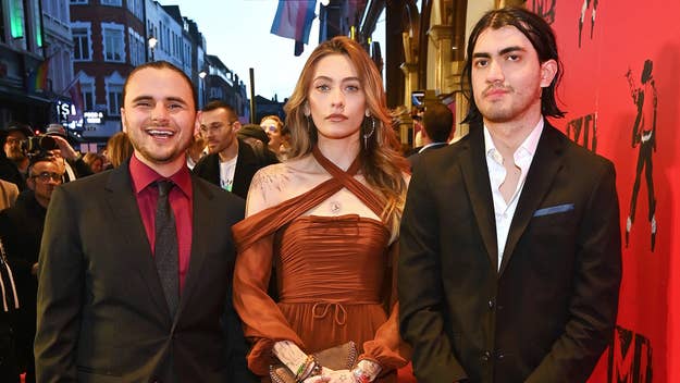 Glen Mazzara, Paris Jackson, and Gabriel Glenn on the red carpet. Paris is wearing an off-shoulder dress, Glen is in a suit and tie, and Gabriel is in a suit without a tie