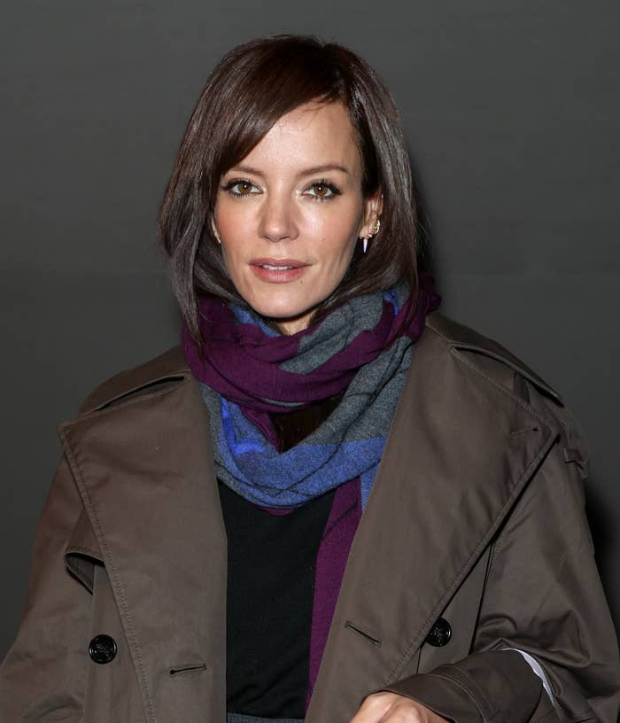 Lily Allen wearing a dark coat and a colorful scarf