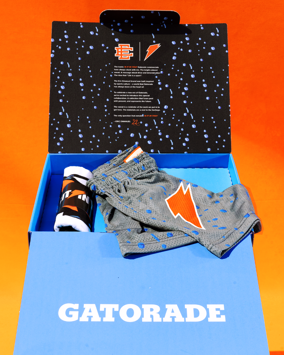 Gatorade gift box with branded shorts, headband, and towel. The lid features a message and two logos: one of Gatorade and one with the initials &quot;EE&quot;