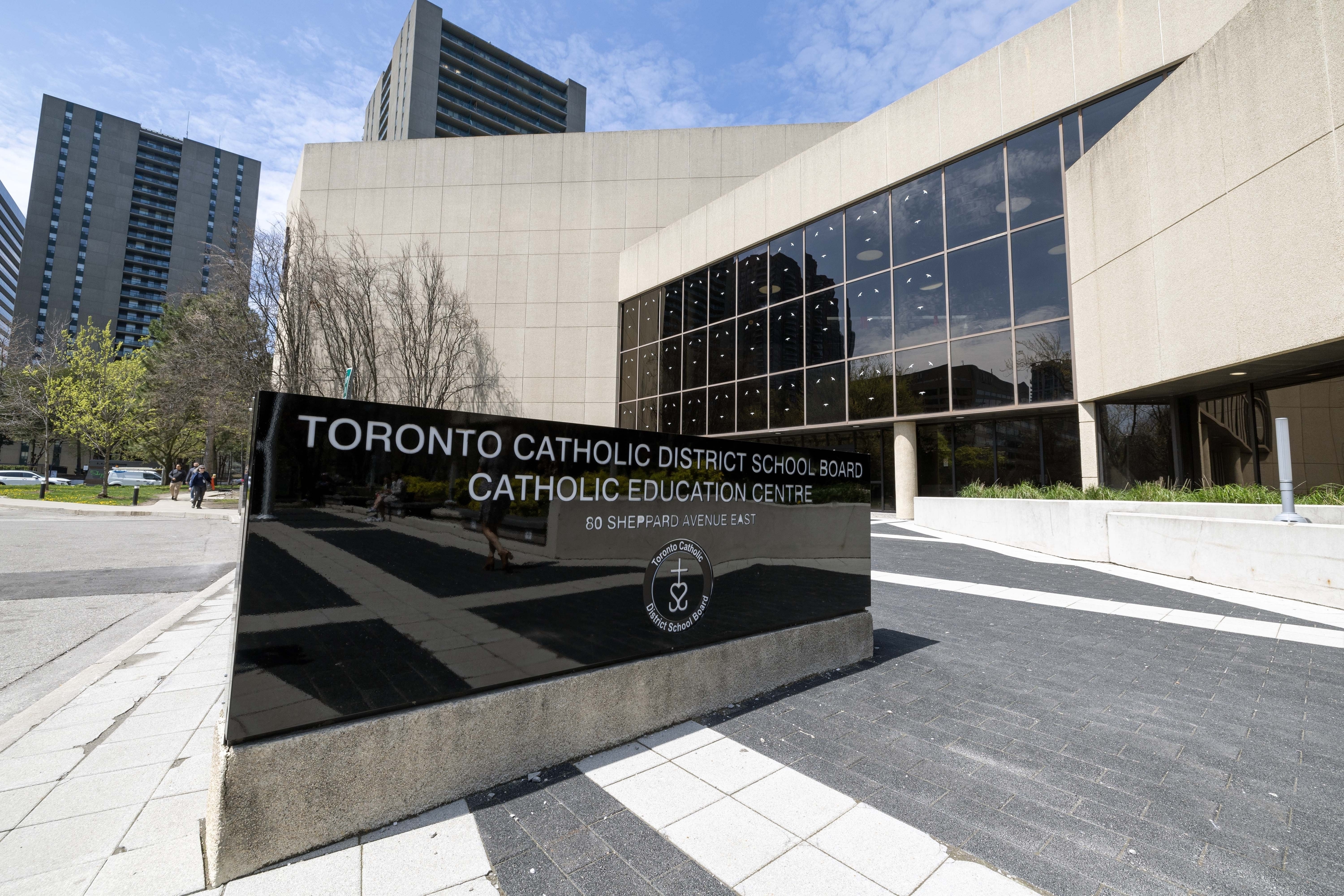 Toronto Catholic District School Board Catholic Education Centre building with a reflective sign in front reading "Toronto Catholic District School Board Catholic Education Centre."