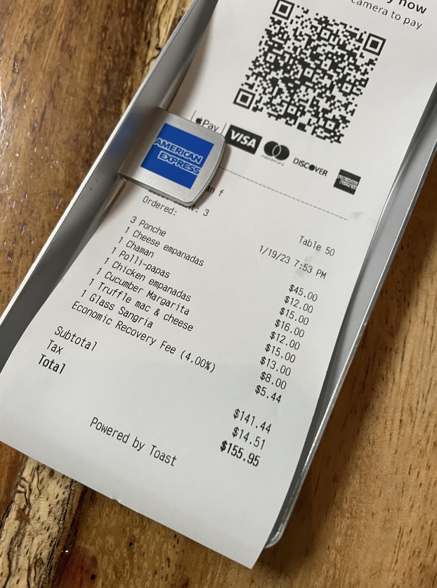 Receipt listing food items including waygu mac & cheese, tamales, pizza empanadas, and a glass of sangria totaling $155.95, including a 4% economic recovery fee