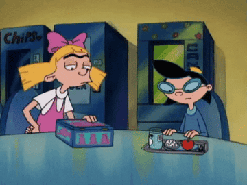 Helga and Phoebe from "Hey Arnold!" are in the school cafeteria. Phoebe looks at a lunch tray while Helga holds a box and talks to her