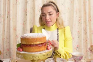 Florence Pugh sitting in front of a Victoria sponge cake