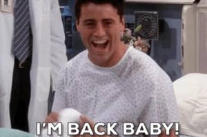 Matt LeBlanc, wearing a hospital gown, sits on a bed and enthusiastically exclaims, "I'M BACK BABY!"