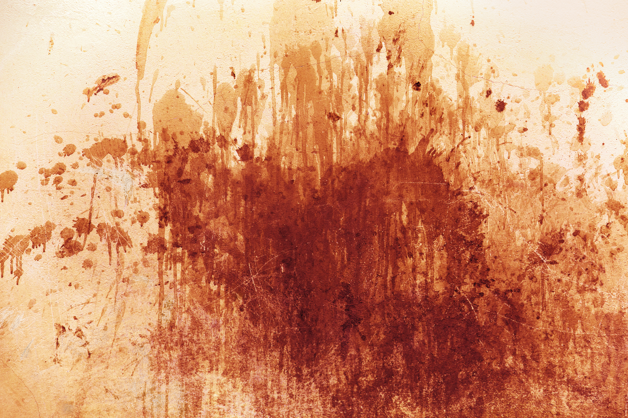 Abstract art with a variety of intense, red splatters and streaks on a light background