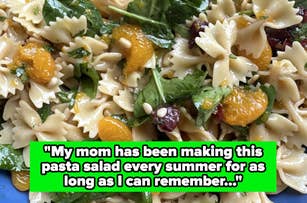 Close-up of a pasta salad with bowtie pasta, oranges, spinach, and pine nuts. The text overlaid reads: "My mom has been making this pasta salad every summer for as long as I can remember…"