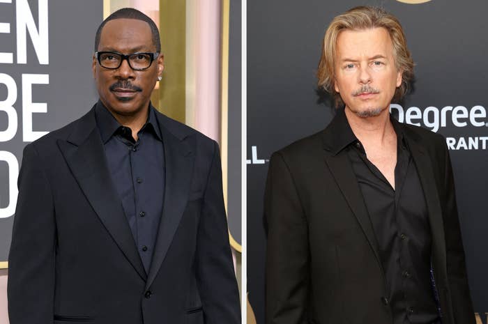 Eddie Murphy and David Spade on the red carpet, both wearing black suits with open-collar shirts