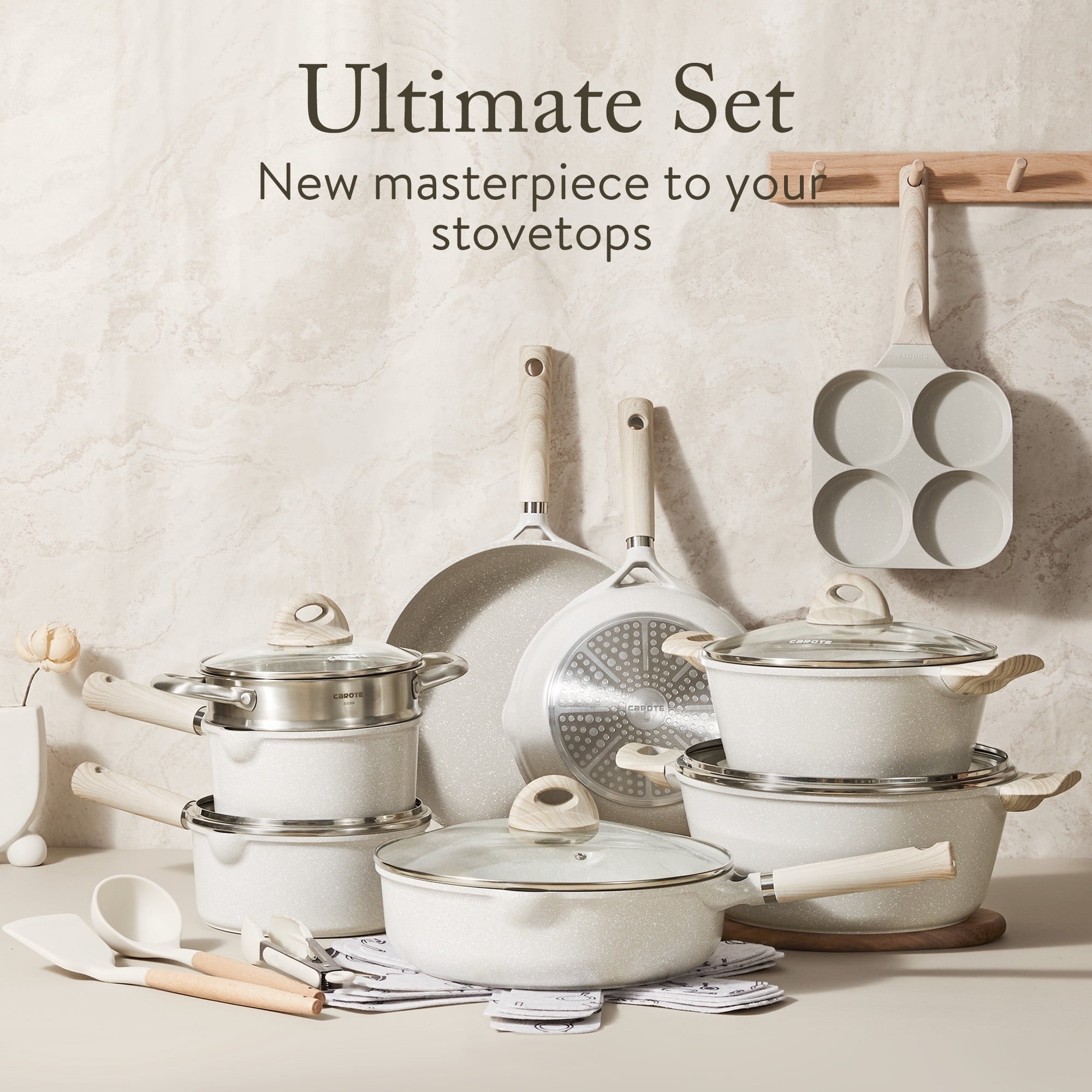Cookware set with multiple pots, pans, and utensils displayed on a wooden surface. Text reads: &quot;Ultimate Set - New masterpiece to your stovetops.&quot;