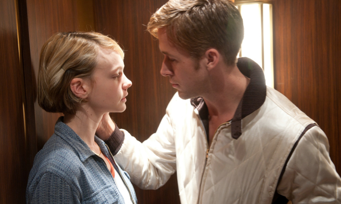 Carey Mulligan and Ryan Gosling in an elevator, gazing at each other intensely. Ryan wears a white jacket; Carey is in a casual outfit