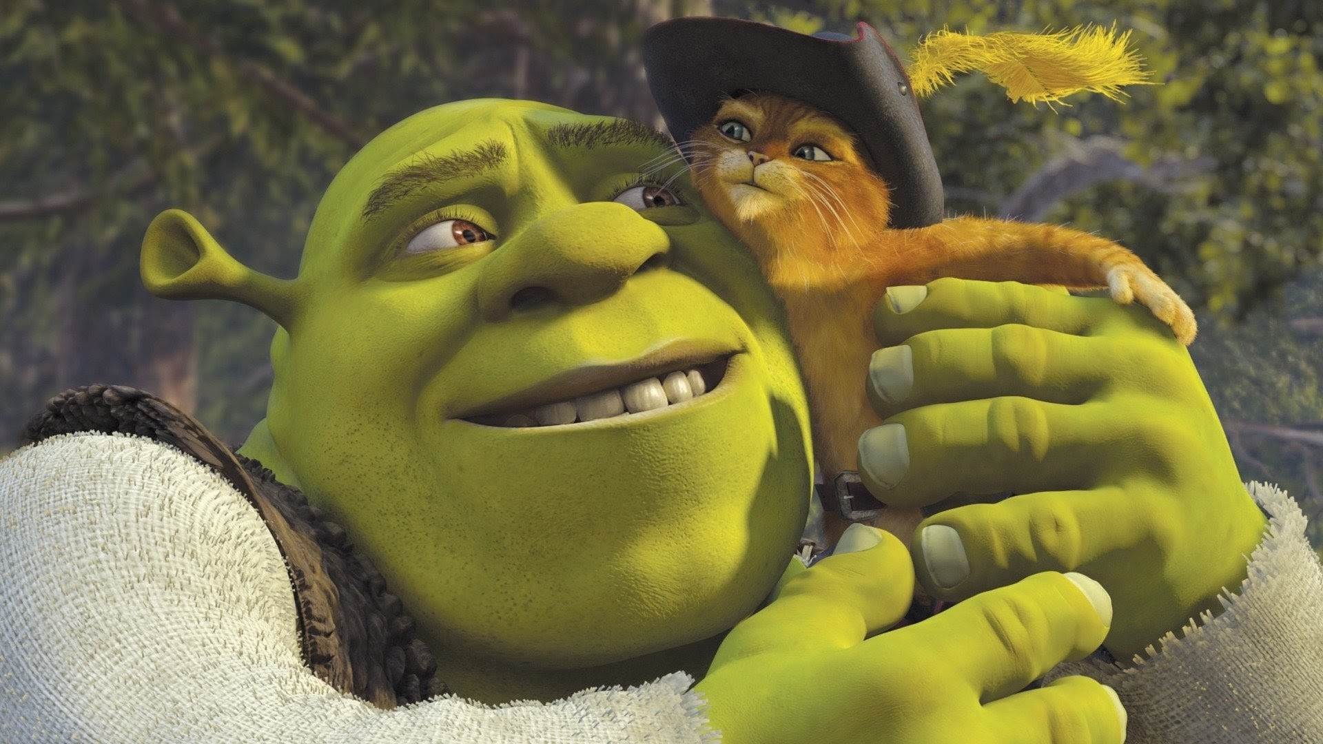Shrek, an ogre, hugs Puss in Boots, a cat wearing a feathered hat, in a forest scene from the movie "Shrek 2."