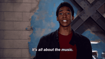A person is speaking and smiling with a caption that reads, &quot;It&#x27;s all about the music.&quot;