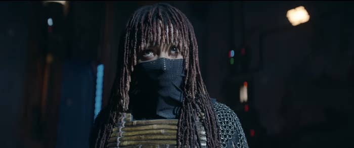 Amandla wearing a face mask and a detailed armor costume looking ahead in a scene from The Acolyte
